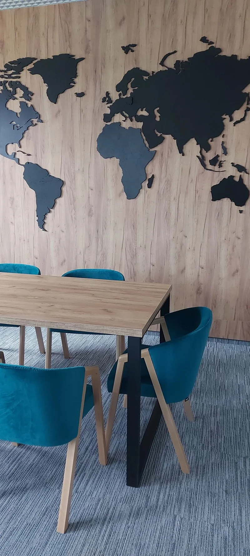 A decorative map of the world on a cladding background with a wood pattern.
