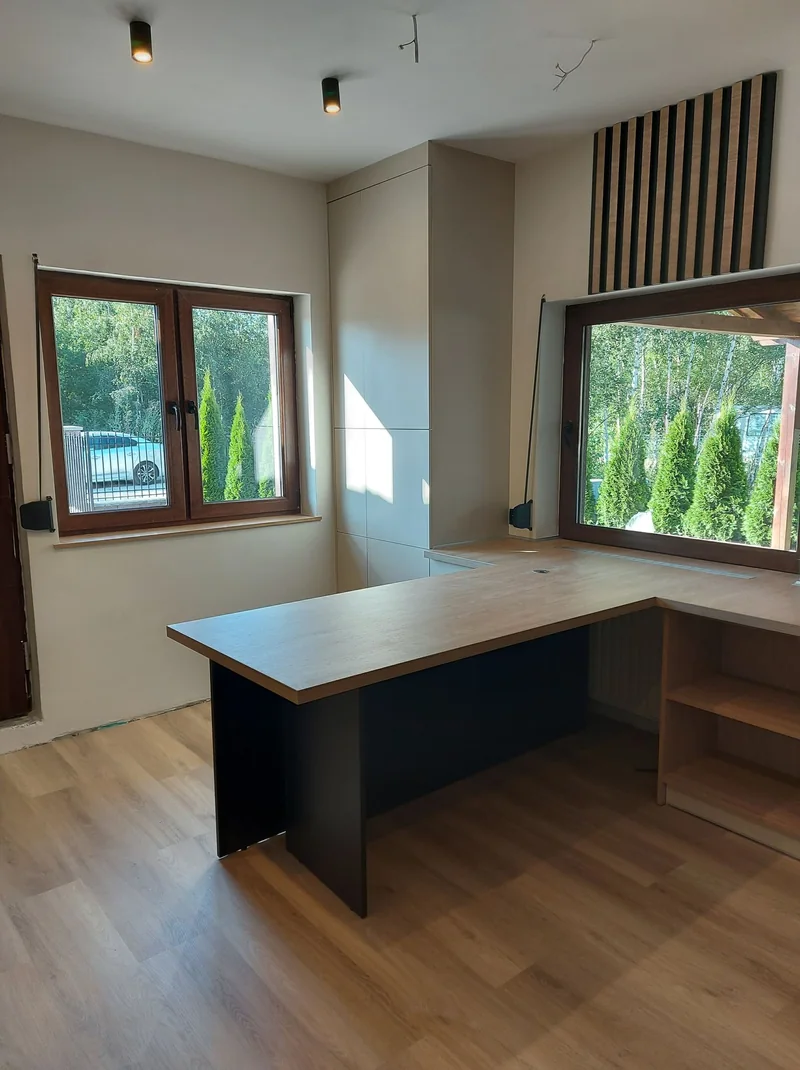 The tabletop by the window and the tall wardrobe make use of the space between the glazing.