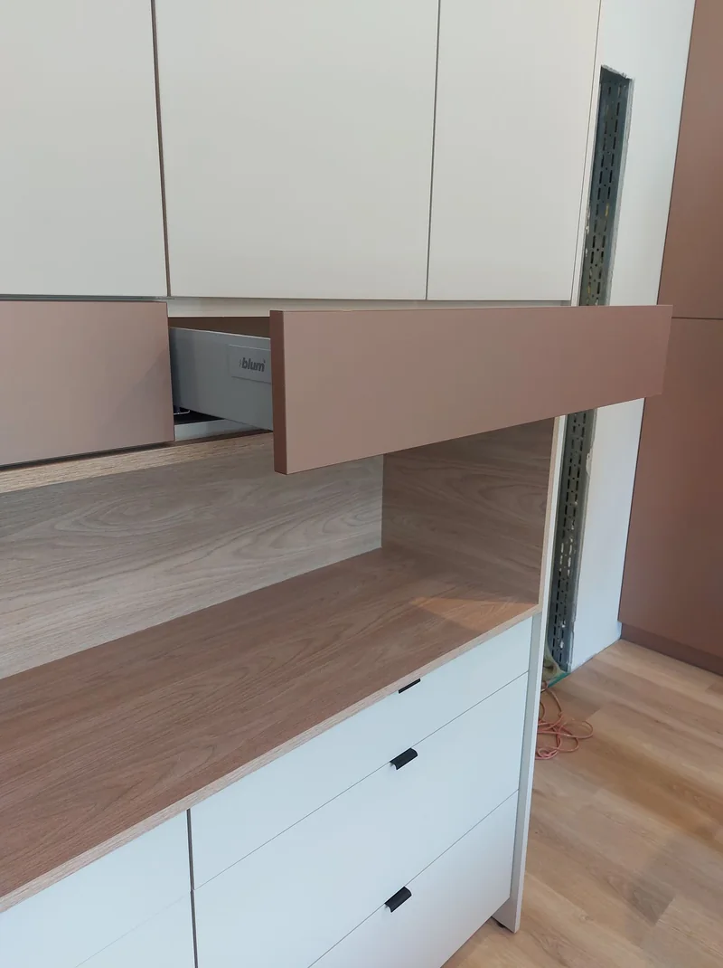 Detail of a pull-out drawer and an open built-in recess.