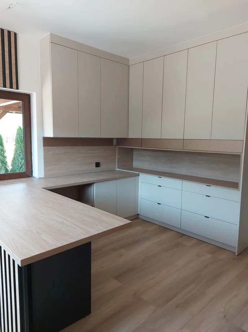 Upper cabinets and rows of drawers organise the storage space.