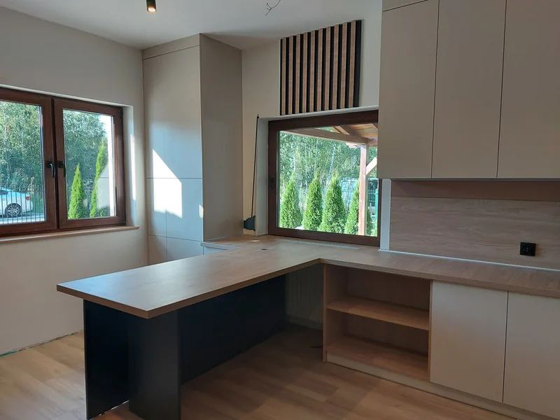 View from the peninsula of the countertop by the window and open shelves.