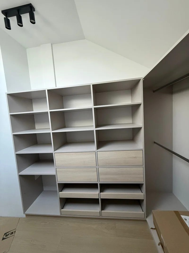 Wardrobe with open shelves, drawers and pull-out shelves.