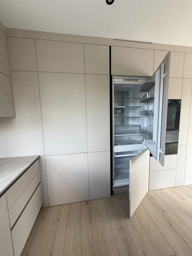 The fridge is hidden behind fronts that match the entire structure.