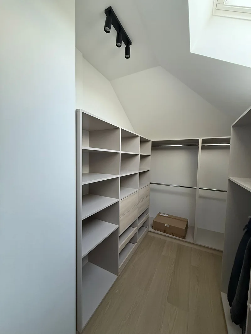 A wardrobe that uses the space under the sloping ceilings.