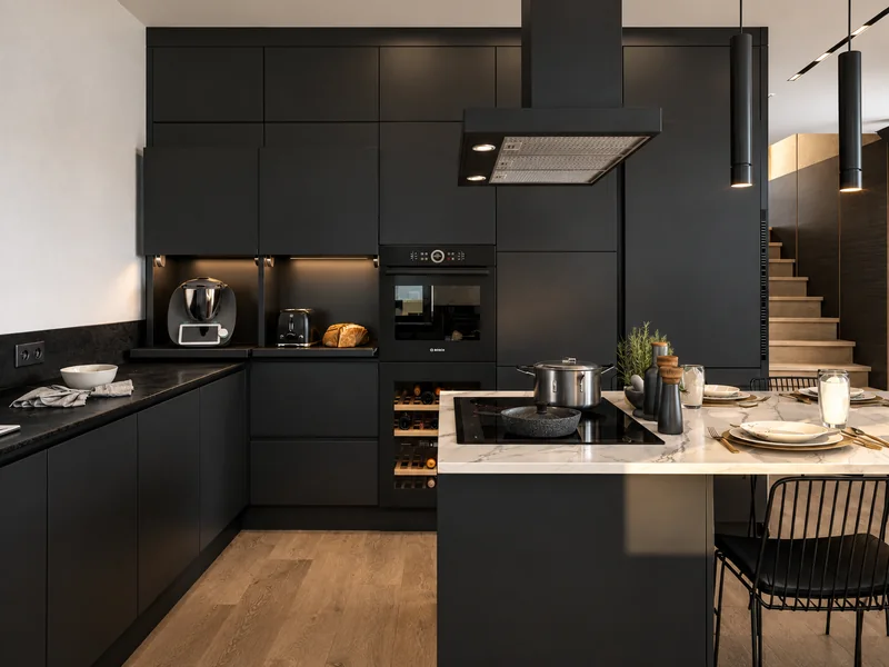 Tall cabinetry with equipment and illuminated work niches.