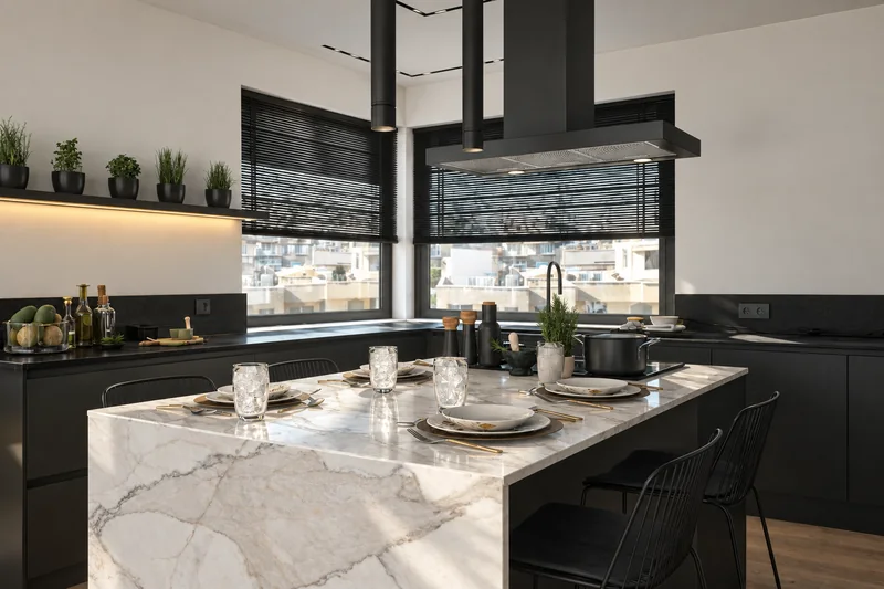 Marble island design, cooking area and natural light from corner windows.