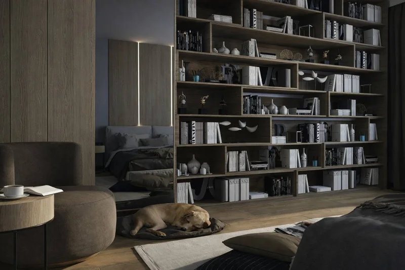 A bookcase covering the entire wall and a reading corner with an armchair and a round table.