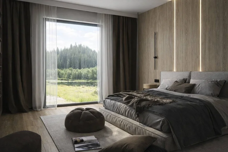 A relaxation area with a soft pouffe and a large window overlooking the greenery.