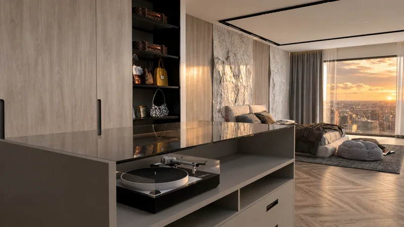 Wardrobe furniture and a chest of drawers with a record player connected to the sleeping area.