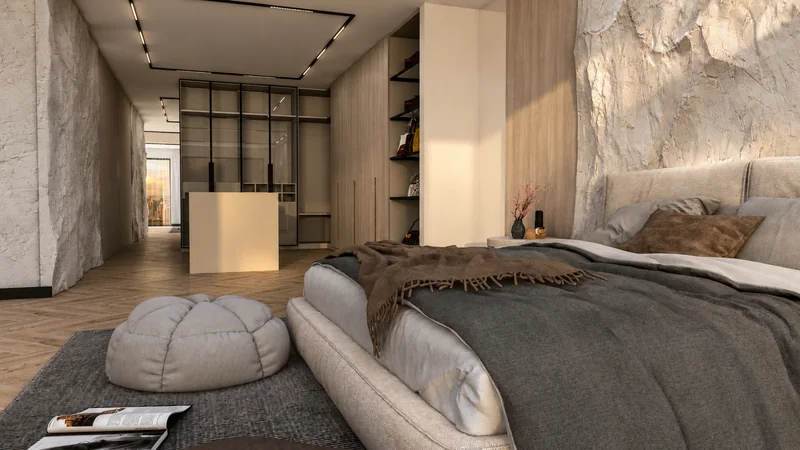 An upholstered bed, a soft pouffe and a view of the wardrobe with glass fronts.