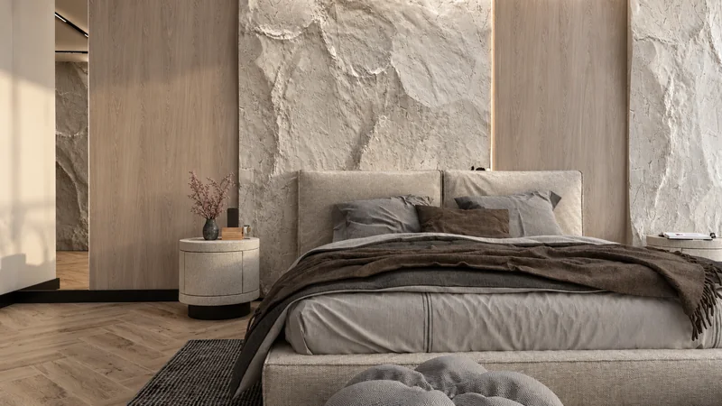A light-coloured bed against a wall with a distinctive texture and wood-tone panels.