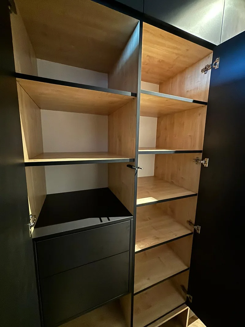 Warm wood finish combined with dark drawers and shelf edges.