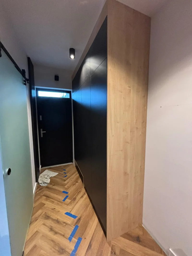 Hallway cabinetry with a wood-toned side panel.